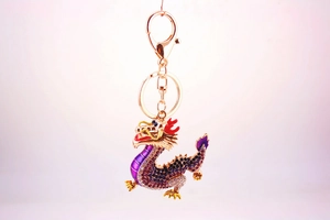 Detailed view of Chinese dragon keychain featuring purple crystals and gold-plated alloy