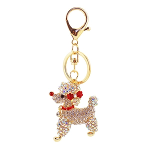 Detail of crystal poodle keychain featuring red rhinestone ears and golden metal clasp