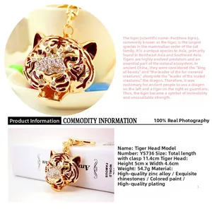 Detailed view of golden tiger head keychain with white rhinestones and brown enamel finish