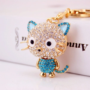 Cute cartoon cat crystal keychain with gold metal plating and sparkling blue rhinestones
