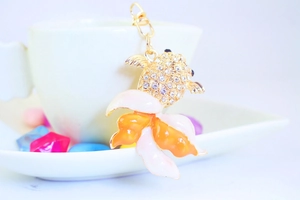 Detailed shot of goldfish keychain with white rhinestones and pink enamel finish
