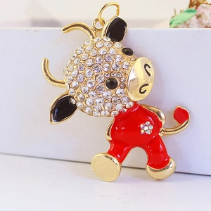 Cartoon ox keychain pendant with sparkling white rhinestones and vibrant red enamel