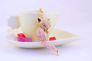 Detailed close-up of crystal fox keychain with pink enamel and gold-plated alloy