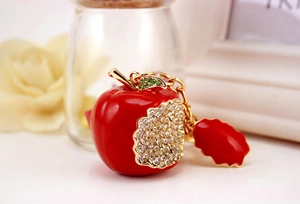 Detailed macro view of a red apple keychain with sparkling rhinestones and gold hardware