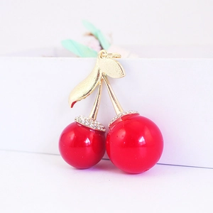 Sparkling cherry keychain with red spheres and gold leaf design for women bags