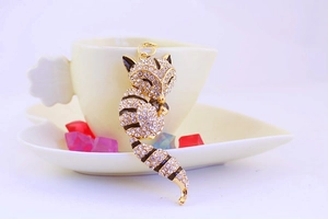 Close-up of crystal fox keychain with gold alloy plating and black enamel tail detail