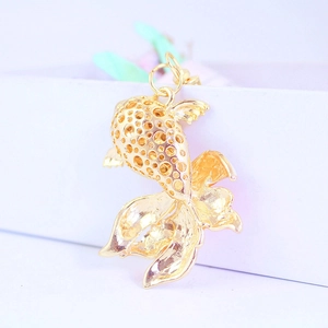 Hollow gold koi fish keychain pendant with intricate metal craftsmanship for ocean lovers