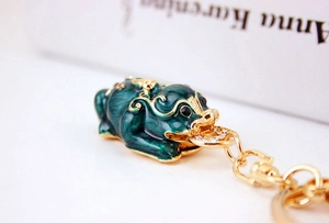 Detail of Pixiu keychain with green enamel finish and sparkling crystal accents