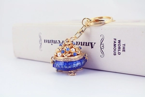 Exquisite gold-plated keychain detail with blue enamel and rhinestone crystal accents