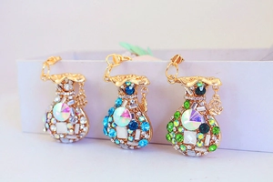 Detailed view of colorful rhinestone money bag keychains with lucky Fu character charms