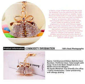 Detail of gold bell keychain featuring sparkling rhinestones and a decorative bow