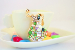 Macro view of crystal money bag keychain with green rhinestones and dollar sign charm