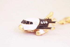 Macro view of A380 airplane keychain with black white enamel and sparkling rhinestones
