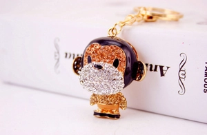 Detailed macro view of monkey keychain featuring gold finish and sparkling rhinestones