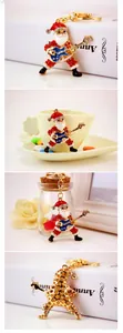 Macro shot of a rock star Santa Claus keychain with sparkling crystals and guitar