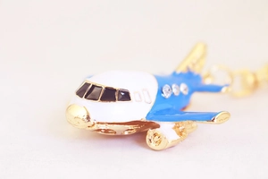 Macro side view of a creative A380 airplane keychain with blue enamel and crystal details
