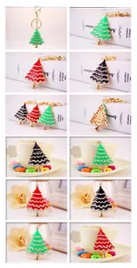 Detailed close-up of colorful enamel Christmas tree keychains with sparkling white crystals