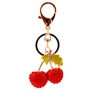 Sparkling cherry keychain featuring red rhinestones and golden leaves on white background