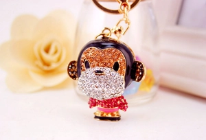 Close-up of cute monkey keychain with vibrant pink rhinestones and gold alloy lobster clasp
