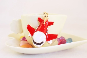 Detail of red and white enamel A380 airplane keychain with crystal rhinestones on a cup