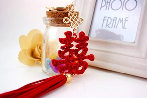 Detail of red crystal wedding keychain with Double Happiness symbol and silky tassel