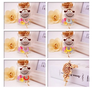 Detailed close-up of cartoon monkey keychains with colorful enamel and sparkling rhinestones