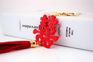 Detail of red Chinese Double Happiness keychain with crystal accents and long silk tassel