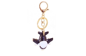Detailed close-up of a cartoon A380 airplane keychain with black enamel and sparkling rhinestones