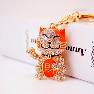Golden Maneki Neko keychain with sparkling rhinestones and red enamel lucky coin accent