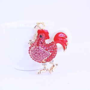 Sparkling rhinestone rooster keychain pendant with red enamel tail and golden finish