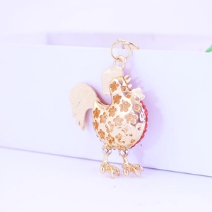 Creative gold rooster keychain with floral hollow design and sparkling crystal accents