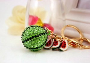 Detailed view of rhinestone watermelon keychain with gold plating and enamel charms