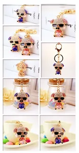 Detail shots of sparkling rhinestone pig keychains with sunglasses in pink and blue colors