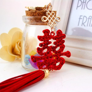 Sparkling red crystal double happiness keychain with gold accents and elegant long silk tassel