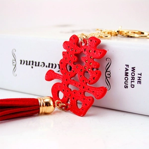 Traditional red Double Happiness keychain with golden ring and elegant tassel detail