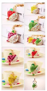 Close-up of apple keychains with colorful rhinestones in red green and pink tones
