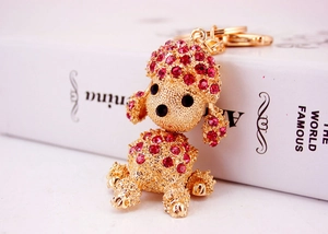 Macro shot of gold poodle keychain with sparkling red rhinestones and spring clasp