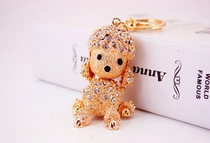 Macro side view of rose gold poodle keychain encrusted with white crystals
