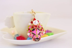 Detail of Chinese Beijing Opera mask keychain with colorful enamel and inlaid rhinestones