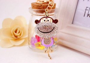 Detail view of monkey keychain with sparkling rhinestones and purple enamel finish