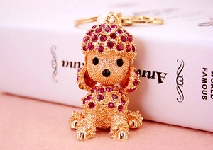 Detail of rose red rhinestone poodle keychain with golden metal clasp and ring