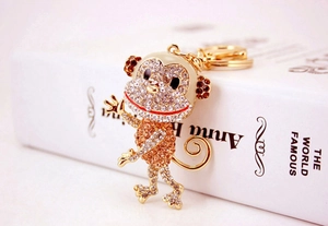 Detailed view of monkey keychain featuring sparkling crystal rhinestones and golden alloy base