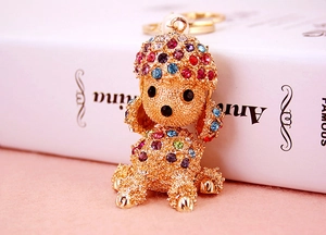 Close-up of colorful rhinestone poodle keychain with pearl accent and gold metal finish