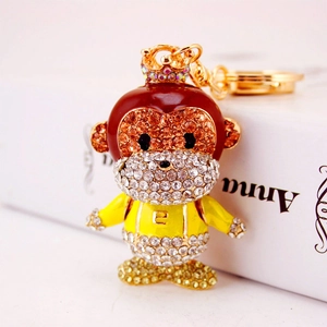 Sparkly crystal monkey keychain with enamel details and crown on gold keyring