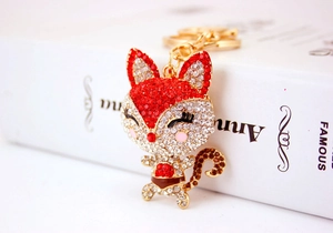 Close-up of sparkling fox keychain with red rhinestones and golden hardware