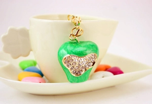 Detail of green apple keychain with enamel marble texture and sparkling rhinestones