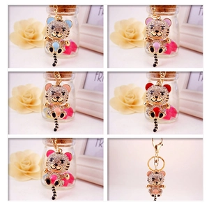 Close-up of sparkling cartoon tiger keychains with rhinestones and colorful enamel detail