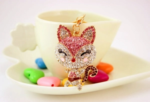 Detailed macro of a sparkling rhinestone fox keychain with gold metal plating