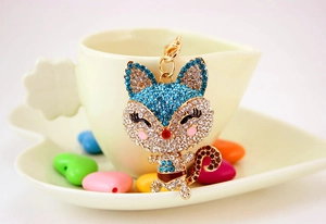 Detailed view of cute rhinestone fox keychain with blue crystals and golden lobster clasp