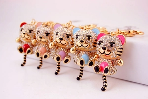 Close-up of five rhinestone tiger keychains in multiple colors with gold plating